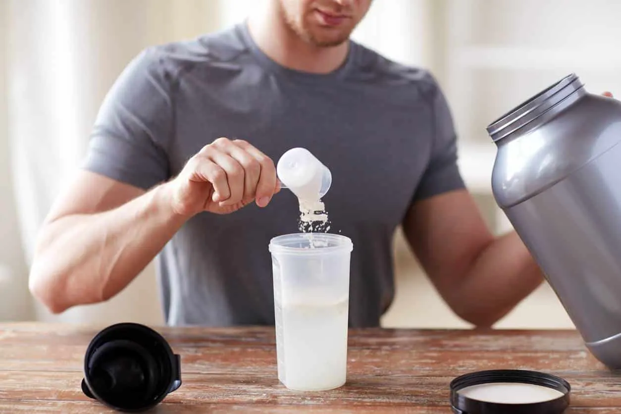 mesure de whey protéine versée dans un shaker de sport